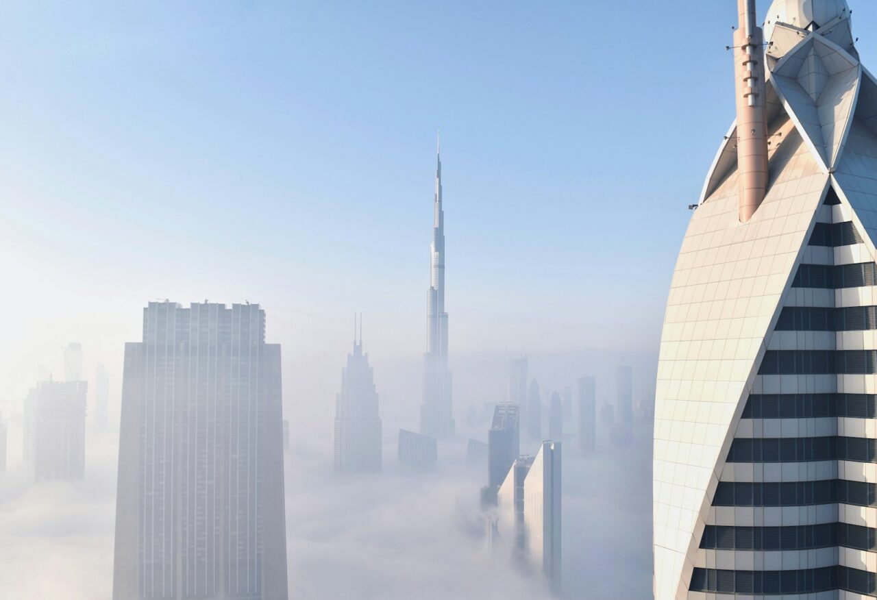 Dubai skyscrapers and the Burj Khalifa rising above a layer of morning fog