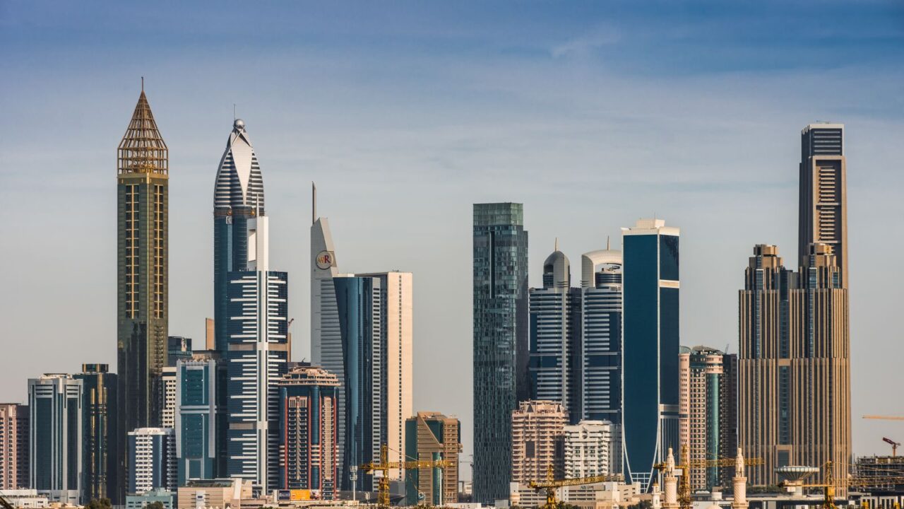 Office towers along Sheikh Zayed Road in Dubai under a clear blue sky